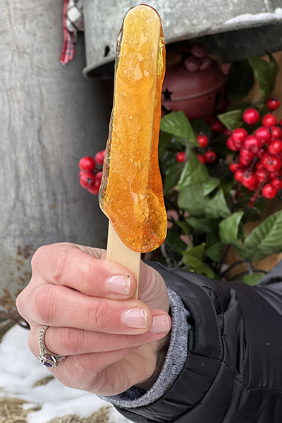 a maple taffy stick from the 'La Petite Cabane a Sucre' store on Rue du Champlain in Old Quebec