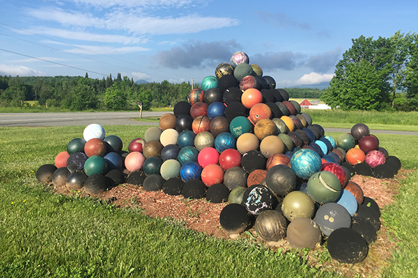 bowling ball pyramid roadside attraction on VT 58 in Lowell, Vermont